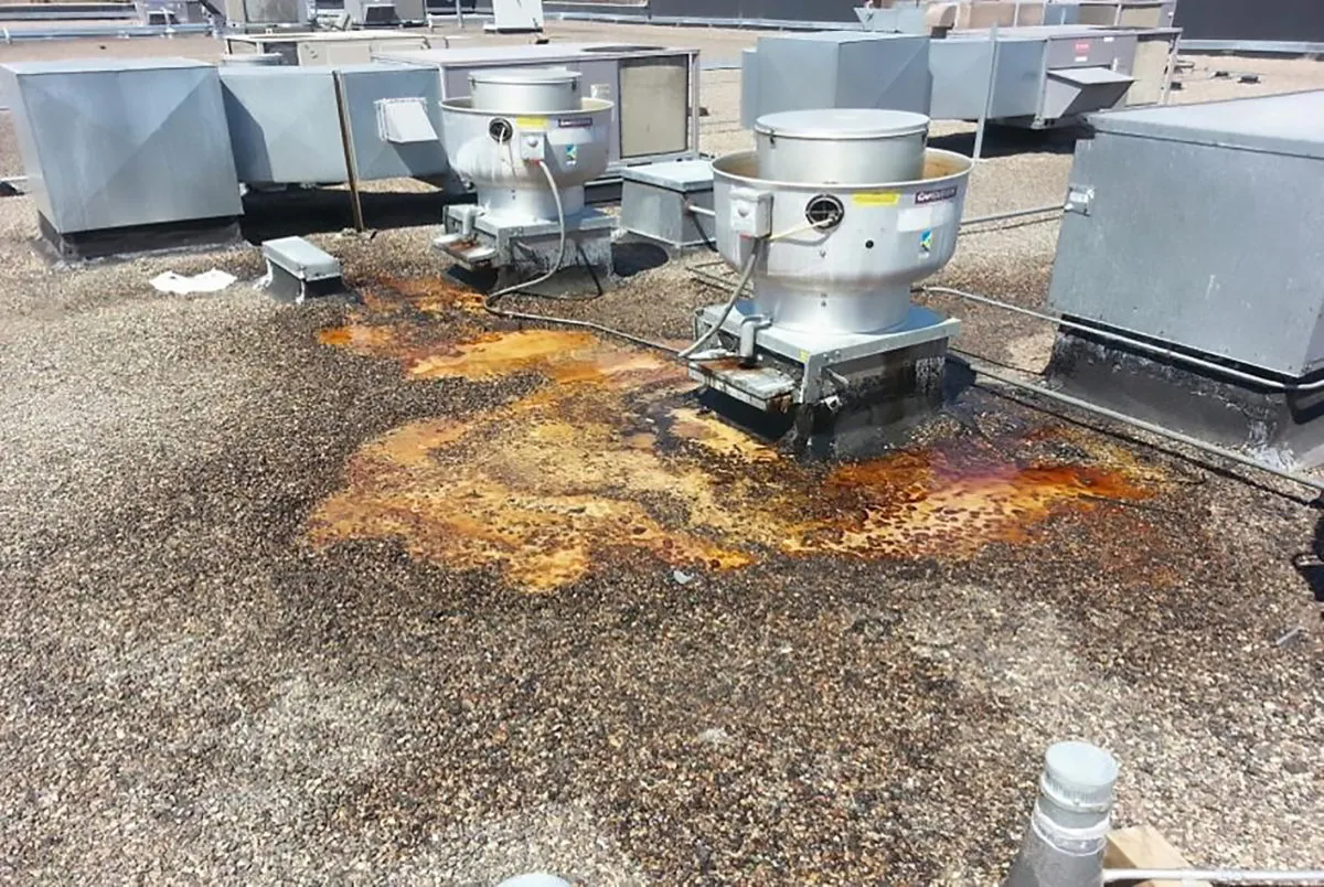 Grease damaged rooftop from kitchen exhaust in Sacramento — before containment system installation